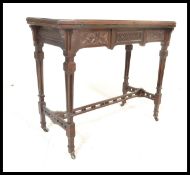 A early 20th Century Edwardian mahogany card table being raised on square carved tapering legs