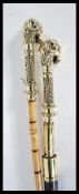 A pair of 20th Century walking sticks/ canes, one having a bamboo shaft with brass rams head a top