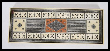 A late 19th Century Anglo Indian Colonial Vizagapatam cribbage board, having ivory, bone and micro