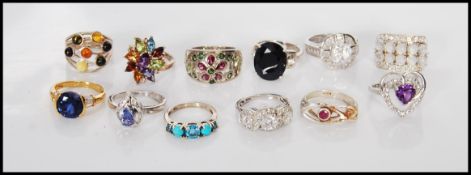 A collection of twelve stamped 925 silver ladies dress rings to include a ladies dress ring set with