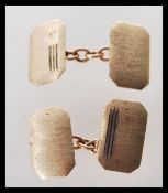 A pair of hallmarked 9ct gold 375 gentlemen's cufflinks of square form. Hallmarked for Birmingham,