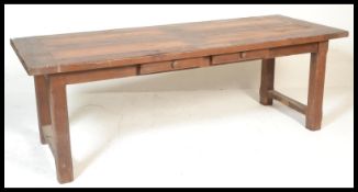 A 20th Century French oak extendable  refectory dining table, the solid rectangular top with rounded