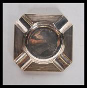 An early 20th Century silver hallmarked ashtray having engine turned decoration to the rims.