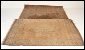 Two late 19th/ early 20th Century rugs, one having orange ground with red borders and geometric