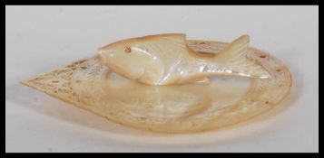 A 20th century engraved foliate mother of pearl dish with pierced decoration of circular form.