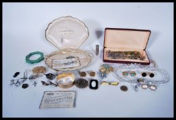 A selection of vintage costume jewellery to include a set of pompadour simulated pearls within a