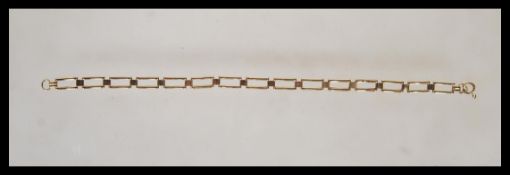 A 9ct gold bar linked bracelet chain with hook and bale clasp. Measures 7