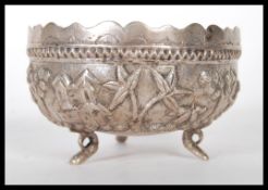 A 20th Century Anglo Indian silver bowl having repousse decoration featuring a landscape with