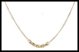 A stamped 9ct gold necklace chain having a fine link chain with section of rope twist on a spring