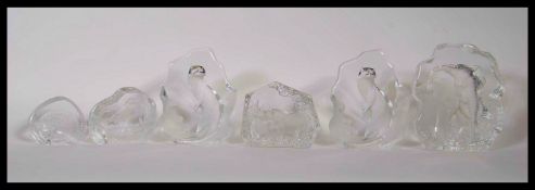 A collection of cut lead glass paperweights with engraved animals to include an elephant, two