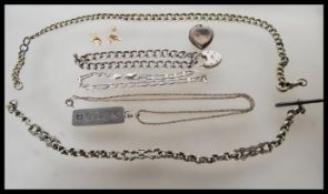 A collection of silver and silver white metal jewellery to include a stamped silver heart shaped