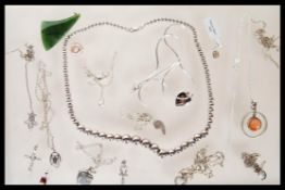 A selection of silver necklaces and pendants to include a heart pendant set with white stones, two