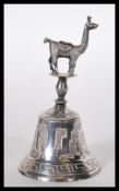 A stamped 925 silver bell having engraved South American decoration to the bowl with an applied