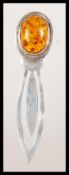 A stamped 925 silver bookmark having an amber cabochon finial. Weight 7.5g.Measures 8cm wide.