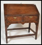 A late 18th / early 19th Century Georgian oak writing bureau desk  having a fall front raised on