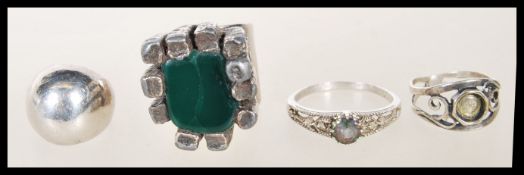 A selection of silver rings to include a stamped 925 ring having pierced decoration set with a