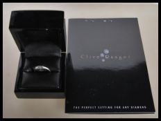 An 18ct white gold and diamond 3 stone ring. Princess cut diamonds in a rub over setting. Diamonds