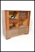 A vintage retro 20th Century walnut cased radiogram containing a four speed Garrard RC121 MKII