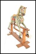An early 20th Century Edwardian dapple grey rocking horse in the manner of Lines Bros, raised on a