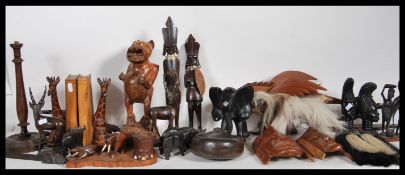 A collection of 20th Century African tribal items to include a hard wood wall hanging face masks,