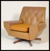 A vintage retro 20th Century circa 1960's Danish inspired easy lounge swivel armchair, the angular