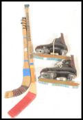A group of ice ickey related items to include two wooden hockey sticks comprising: Checking and