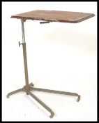 A mid century adjustable reading stand / lecturn. Raised on a cast metal spider base with castors