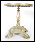 A Victorian 19th Century brass trivet stand, having pierced decoration top and knopped tapering