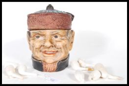A early 20th Century Austrian ceramic tobacco jar in the form of a male head wearing a hat with
