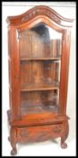 A 20th century hardwood French style armoire display cabinet. Having a large arched glazed door to