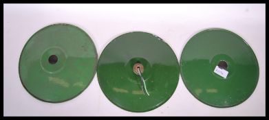 A set of three vintage 20th Century industrial enamel factory shades, the shades of UFO form,