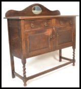 An early 20th Century Edwardian oak mirror back sideboard / credenza, fitted with a pair of panel