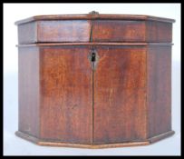 A 19th Century Georgian mahogany tea caddy in octagonal form having a hinged lid opening to reveal a