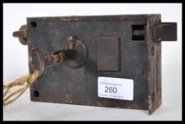 An 19th Century Victorian  wooden and iron door lock and key, key and lock moving freely.