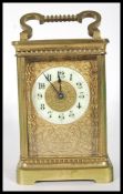 A early 20th Century brass French carriage clock having white enamel chapter ring with arabic