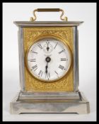 A 20th Century German made carriage clock. The clock of classical form, chrome case with gilt rococo