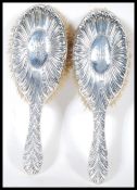 A pair of Victorian 19th century silver hallmarked ladies clothes brushes by Willam Comyns bearing