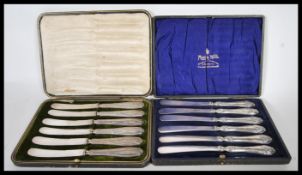 Two cased sets of silver handled butter knives to include a set of six Harrison Fisher & Co silver