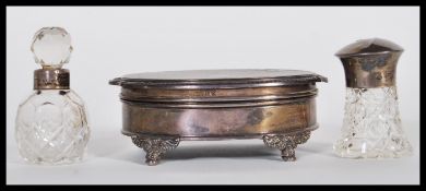 A mid 20th Century silver hallmarked dressing table box of oval form raised on four scrolled feet,