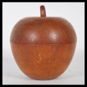 A 20th century turned / treen fruitwood tea caddy in the form of an apple, the apple in two parts