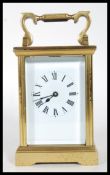 A 20th Century brass cased four pane carriage clock having a white enamelled face with roman
