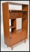 A retro 20th Century teak wood Danish inspired room divider - bookcase having an arrangement of
