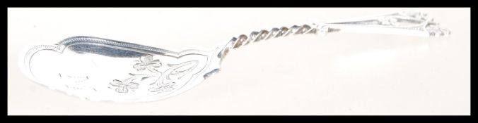 A hallmarked silver caddy spoon having foliate engraving. Having assay marks for Sheffield dated