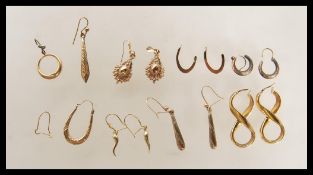 A group of 9ct gold earrings to include hoop, lozenge shape and other style drop earrings, stamped