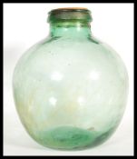 A vintage 20th century large bluish green glass carbouy of bulbous form.
