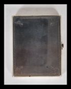 An early 20th Century silver hallmarked vesta case having an engine turned exterior with scrolled