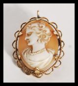 A 9ct gold / 375 marked ladies cameo brooch depicting a maiden facing left, pin verso with