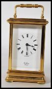 A 20th Century St James of London gilt brass carriage clock, the enamel dial with Roman numerals, on