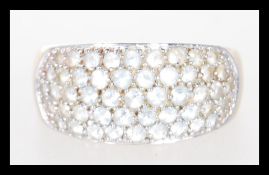 A hallmarked 9ct gold ring set with five rows of white stones to the head. Hallmarked Birmingham