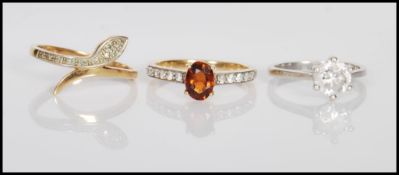 A group of three 9ct gold ladies dress rings to include a stamped 375 ring having an oval cut